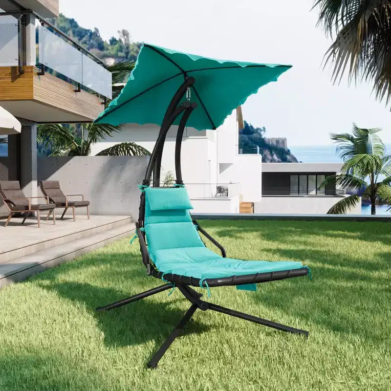 Outdoor hammock-style lounge chair with parasol, curved steel frame, and soft cushions, perfect for patios, gardens, and poolside areas.